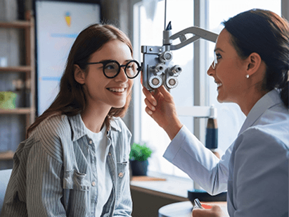 Young woman consulting with optometrist during eye checkup