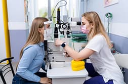 Patient trying on corrective trial prescription lenses